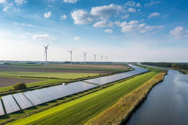 A combination of solar panels, wind turbines, and a water energy source representing sustainable Solar BC energy solutions.