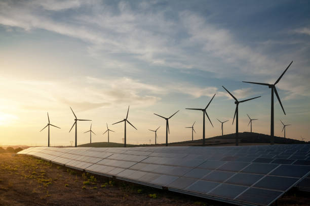 A solar and wind energy farm with large solar panels and wind turbines, showcasing the renewable energy solutions provided by Solar BC.